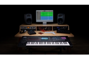 Roland digital synthesizer workstation connected to studio audio hardware and music production software